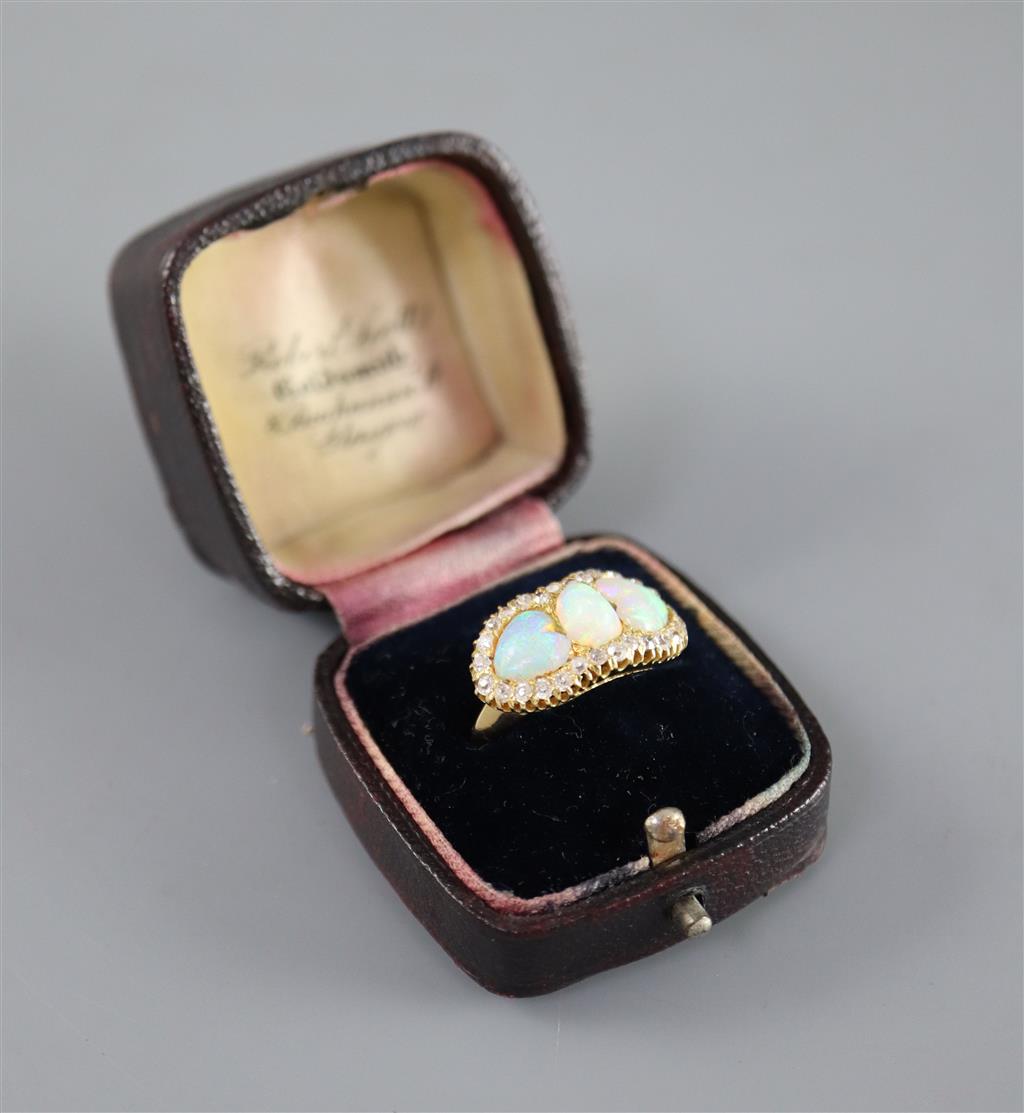 A gold, three stone white opal and diamond set cluster ring,